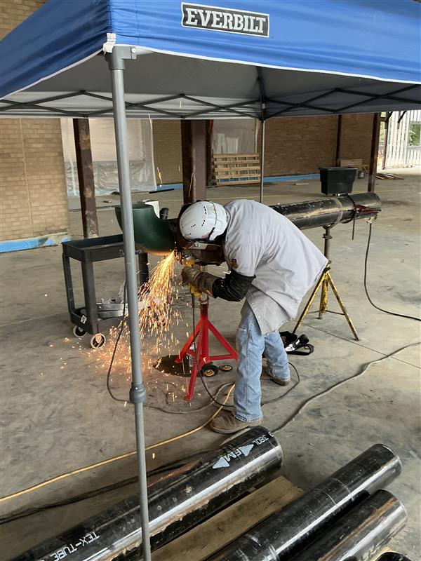 Mechanical tradesperson working on pipe fabrication